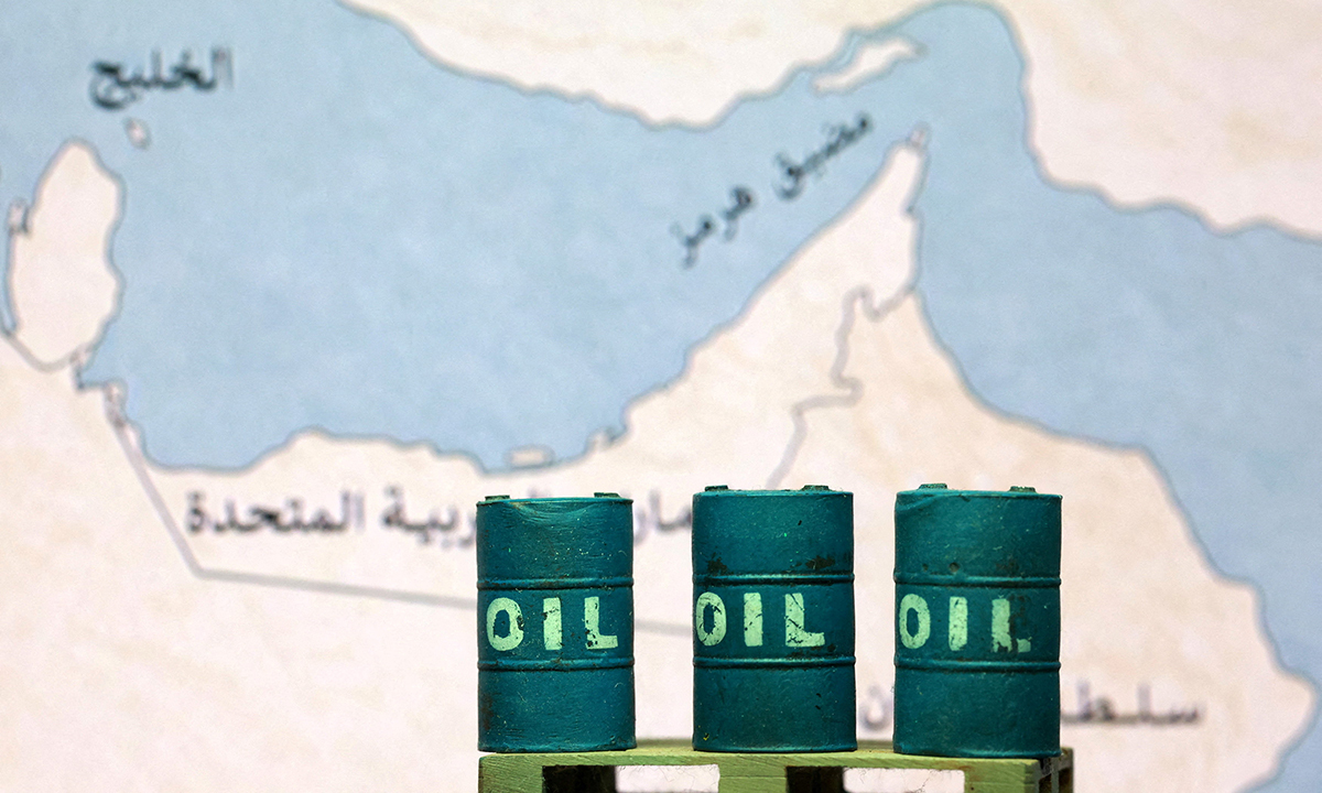 FILE PHOTO: A map showing the Strait of Hormuz, also known as Madiq Hurmuz, and 3D printed oil barrels are seen in this illustration taken March 26, 2026. REUTERS/Dado Ruvic/Illustration/File Photo