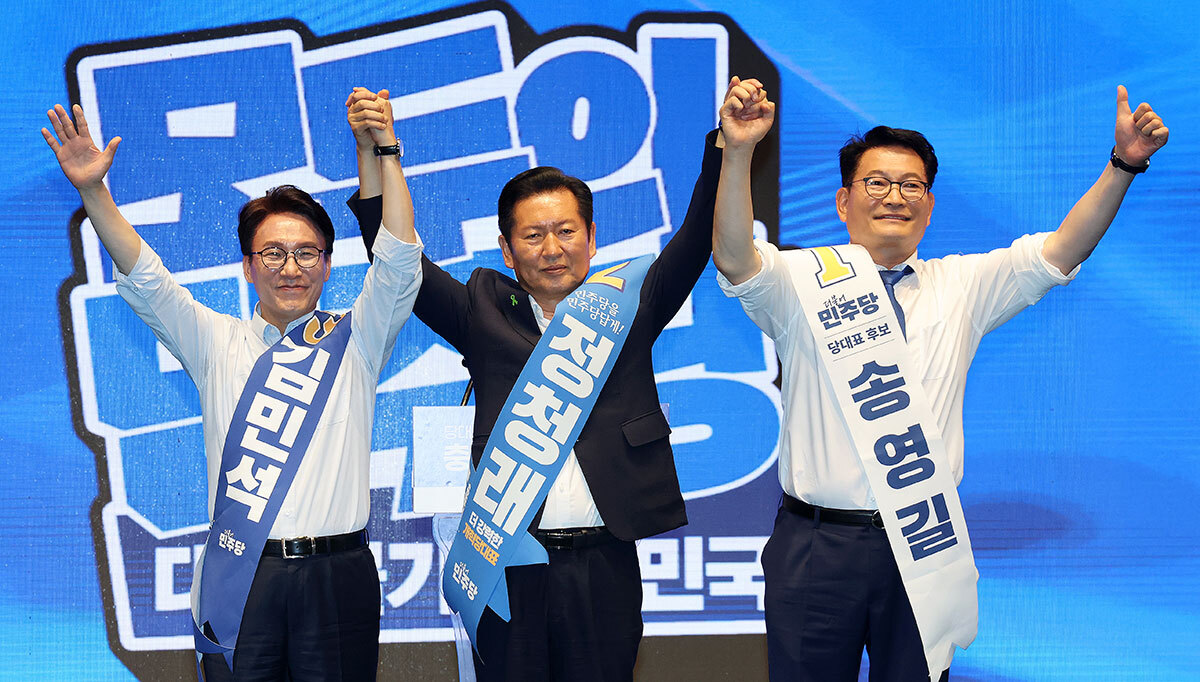 더불어민주당 김민석(왼쪽부터), 정청래, 송영길 당 대표 후보가 1일 충북 청주시 CJB미디어센터에서 열린 당대표·최고위원 순회경선 합동연설회에서 손을 맞잡고 인사하고 있다. 연합뉴스